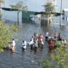 A group of hurricane katrina survivors wade through flood waters