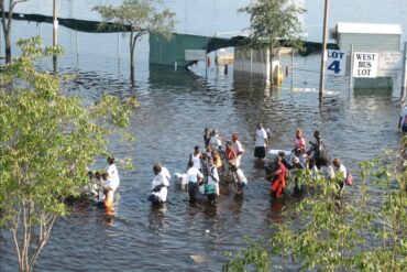 A group of hurricane katrina survivors wade through flood waters